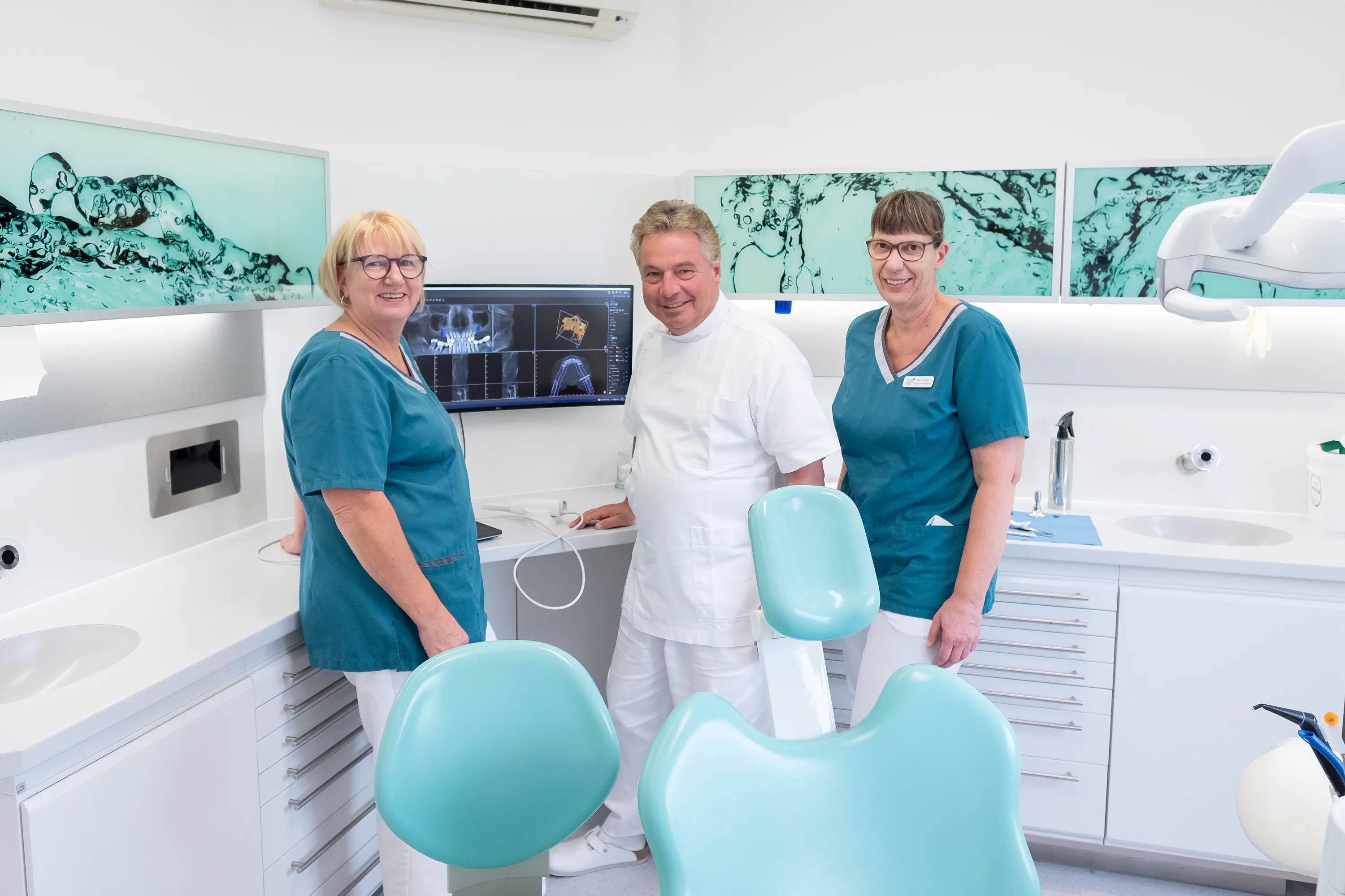 Frank Stryga mit zwei Mitarbeiterinnen im Behandlungszimmer
